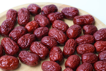 Side view Natural sweet dried jujube on wooden tray. Background