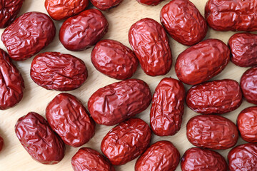 Top view Natural sweet dried jujube on wooden tray. Background. Healthy fruit