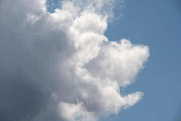 Beautiful white and grey clouds on partly blue sky..