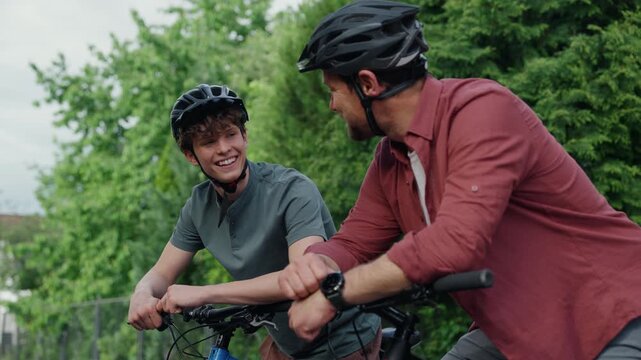 Dad and teenage son during fun cycling trip. - Powered by Adobe