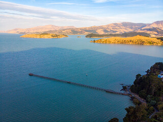 Aerial view of Governors Bay jetty near Lyttelton, Banks Peninsula, South Island, New Zealand, with...