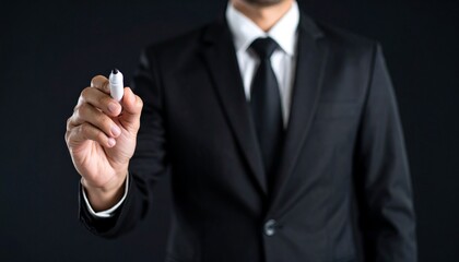 Fototapeta premium Business wallpaper of a man in a suit holding a pen and pointing somewhere