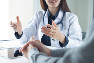 Female doctor advices to male patient about checkup result, medical screening, giving consultation on appointment at medical clinic, hospital office, close up