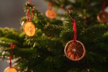 Closeup small christmas tree with natural decorations indoor