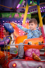 Smiling Boy Enjoys Colorful Magic Carpet Ride at Fair