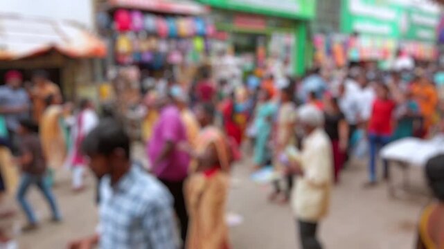 Bokeh view of crowded market street in Chennai, India. Blurred background footage.