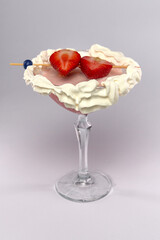 Delightful Strawberry Dessert Cocktail with Whipped Cream and Fresh Fruit Garnish in a Stylish Glass for a Sweet Indulgence