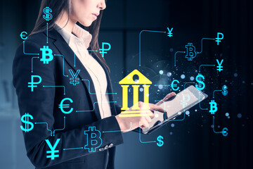 Businesswoman using digital tablet with online banking interface and global currency icons on dark background representing fintech innovation.