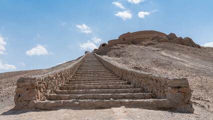 The ancient Zoroastrian Towers of Silence in Yazd, elevated circular structures on arid hills, under a vast sky