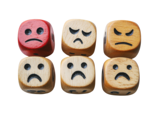 Wooden dice with sad and angry faces, representing emotions and negative feelings in life