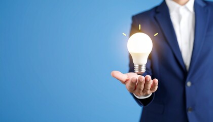 3D scene with a lightbulb-shaped idea icon floating above the hand of a blurred man in a suit