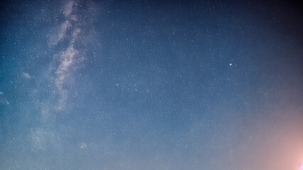 Bright water drops on a black wall with blue clouds and abstract texture