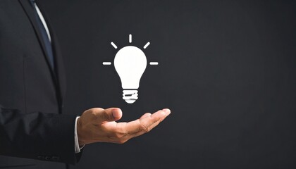 3D scene with a lightbulb-shaped idea icon floating above the hand of a blurred man in a suit