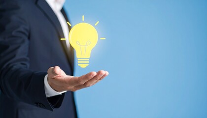3D scene with a lightbulb-shaped idea icon floating above the hand of a blurred man in a suit