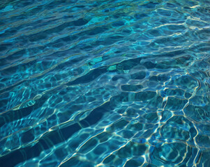 Obraz premium Rippling blue water surface with light reflections ripples