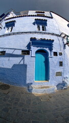Blue door in a blue wall in the medina in Chefchaouen, Morocco