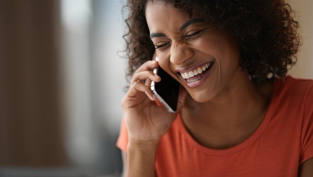 Portrait of a happy african american woman talking on mobile phone and smiling widely