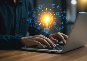 Person typing on a laptop with a glowing lightbulb and business innovation icons, representing new ideas, creative solutions, and inspiration.
