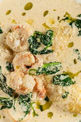 Close-up of juicy shrimp in a creamy parmesan sauce with wilted spinach and olive oil, capturing the richness and texture of an elegant seafood dish. Perfect for gourmet and restaurant themes.