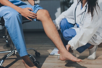 Physical therapist teaching a patient how to do exercises for his knee pain