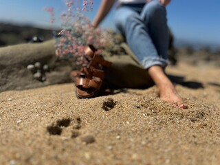 on the beach girl in a white t-shirt and jeans with flowers