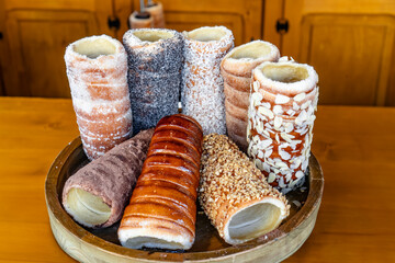 A wooden tray with a variety of pastries, including some with nuts