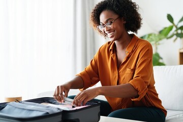 Woman packing suitcase for travel vacation trip holiday preparation tourism journey