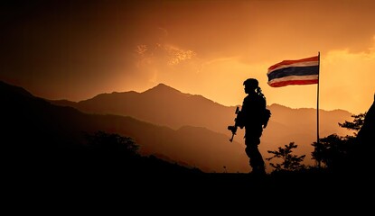 Silhouette of soldier against sunset and Thai flag