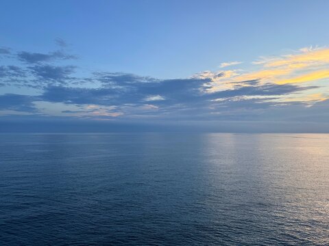 Calm sea peaceful water and dark dusk clouds in the sky.