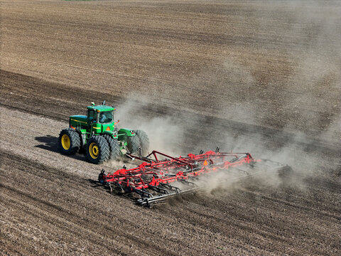 Oglesby, Illinois - USA - April 29, 2025 Aerial view of a John Deere 9400 tractor pulling a Case IH 255 cultivator
