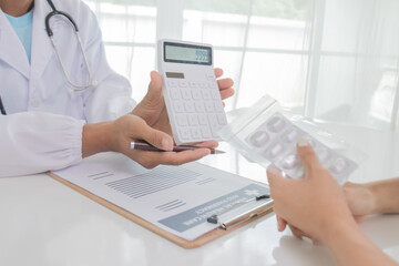 Fototapeta premium Young Asian male doctor consults teenage patient in hospital, explains diagnosis, prescribes treatment and gives advice with trust and expertise in hospital.
