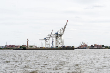 Port with cranes and war ships in Hamburg Germany