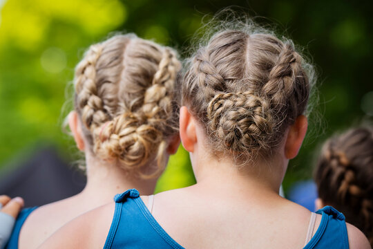 French Braid Hairstyle on dancers. Portrait of the back of a young girls wearing French braids in her hair. 