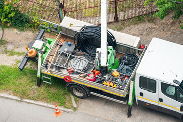 Cables, wires and various tools on the platform of a truck. Repair of power lines
