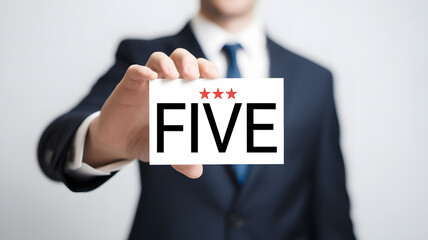 Businessman Holding Sign Reading "FIVE"