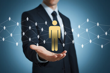 Businessman's Hand Holding a Gold Icon Representing a Person in a Network