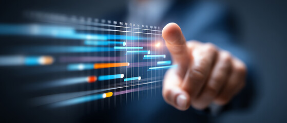 A hand interacts with a futuristic digital interface displaying colorful data bars and timelines, symbolizing advanced technology, data analysis, and project management