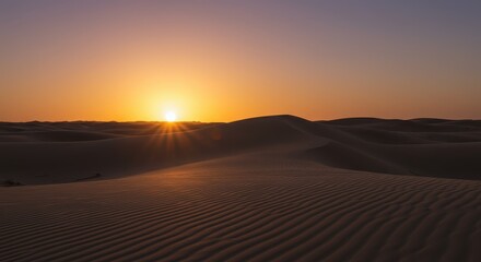 Dramatic desert vista featuring undulating sand dunes at sunset with vibrant orange hues