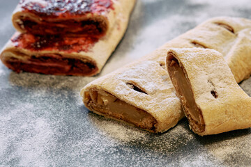 Deliciously Baked Pastries with Sweet Fillings Showcased on a Flour-Dusted Surface for a Tempting...
