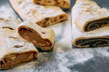Deliciously Baked Sweet Rolls Stuffed with Rich Fillings, Generously Dusted with Powdered Sugar,...