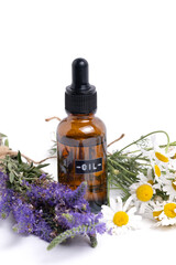 Essential oil with chamomile and lavender on white background.