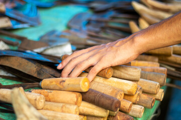 A man holds a sharp iron weapon in the market
