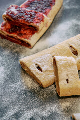 Deliciously Baked Pastries Filled with Sweet Jam and Powdered Sugar Providing a Tempting Treat for Any Dessert Lover's Palate