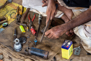 A man repairs old products in the market