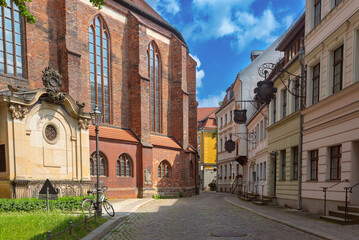 Historic street with St Nicholas Church and traditional houses in Nikolaiviertel Berlin Germany