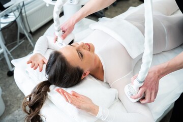 Woman receiving a body sculpting treatment at a wellness center