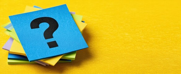 The blue sticky note with a question mark on a vibrant yellow background.