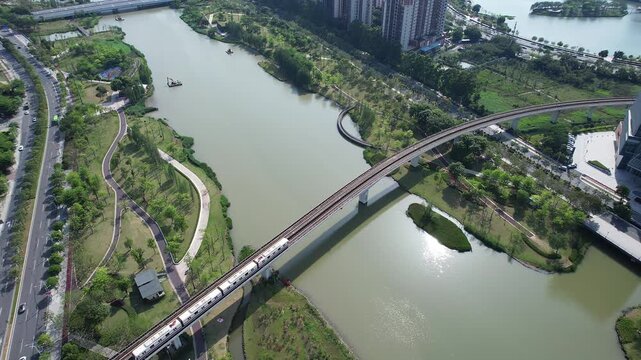 Exploring the scenic river and railway views in Nansha City with lush landscapes and modern infrastructure
