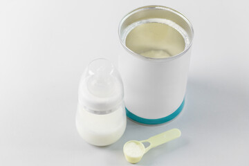 Prepared baby formula with bottle and can. Baby care.