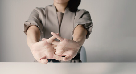 Beautiful Asian girl is tired from working on a chair. She stretched to relax her muscles. while working at the office. Health concept